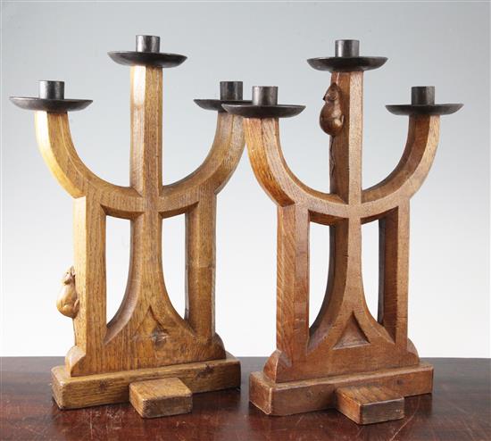 A pair of Robert Mouseman Thompson carved oak three light candelabra, 15in.